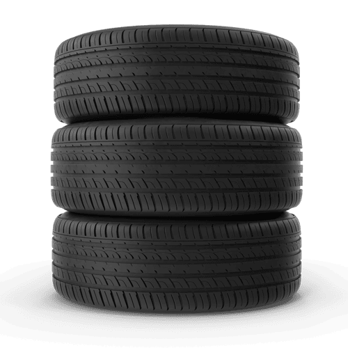 Stack of three high-performance tyres ready for installation at a tyre shop